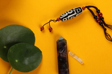 Tibetan dzi bead amulet necklace, tibetan singing bowl and other Success and prosperity symbols on...