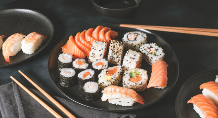 Japanese sushi food. Maki ands rolls with tuna, salmon, shrimp, crab and avocado. Top view of assorted sushi. sushi roll, uramaki, hosomaki and nigiri.