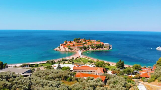 Aerial view of Sveti Stefan, island in Montenegro surrounded by Adriatic coast. Drone aerial 4K footage