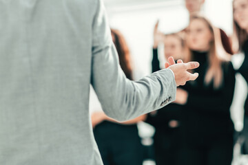 cropped image of a speaker making a presentation at a seminar.