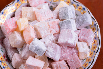 Sweet ,delicious, and colorfull rahat lukum on the plate.