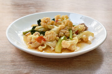 spicy stir fried cauliflower with carrot and pork on plate