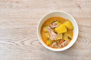 spicy boiled pumpkin with slice pork in curry on bowl