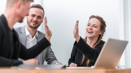 confident business colleagues giving each other a high five