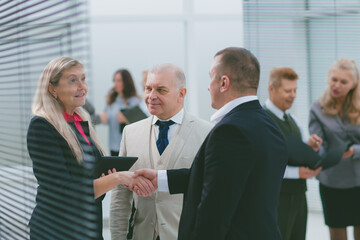 businesswoman and businessman shaking hands before the meeting