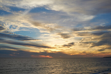 Sunset seascape with colorful cloudy sky. Beautiful sunset over Atlantic ocean