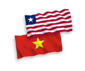 National vector fabric wave flags of Liberia and Vietnam isolated on white background. 1 to 2 proportion.
