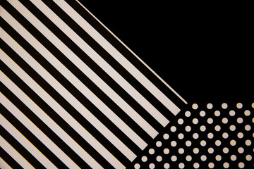 The paper is black and white. Different geometric shapes. White circles and stripes. Abstract...