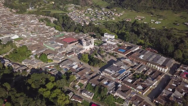 Aerial Drone orbiting around the main square in Silvia,  Colombia. Angled down toward the Our Lady of Perpetual Help Church