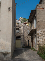 Fototapeta na wymiar View of narrow streets of old romantic mountain village Baunei with stone houses. Ogliastra, Sardinia, Italy, Sunny summer afternoon