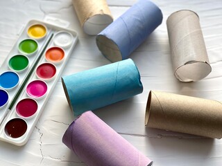 Paint watercolors and colored toilet paper rolls, kids craft.
