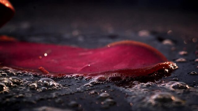 Turkish bacon (Pastırma) is thrown on the grill in slow motion. Turkish pastrami is cooking on the grill.