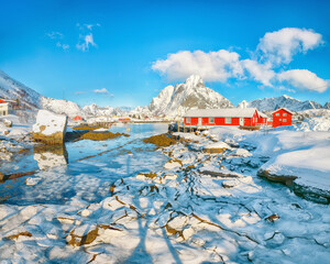 Breathtaking winter sunny view on Reine Village and Gravdalbukta bay with cracked ice.