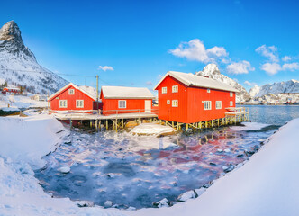 Gorgeous winter  view on Reine Village and Gravdalbukta bay with cracked ice