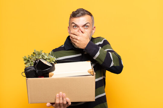 adult man covering mouth with hands with a shocked, surprised expression, keeping a secret or saying oops