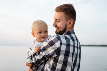 Young father holding his infant child.