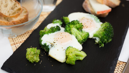 breakfast of crumpled eggs with broccoli