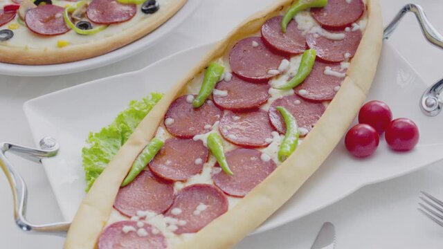 Turkish food and Turkish cuisine. Turkish sausage (sucuk) pita. Freshly baked donuts come out of the oven. Turkish Pide.