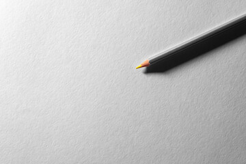 Colored pencil on blank white textured surface. Drawing tools in art studio.