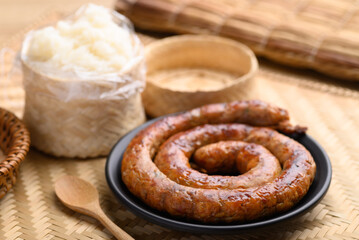 Northern Thai sausage (Sai Aua), Grilled intestine stuffed with minced pork, spices and herbs eating with sticky rice, popular food in Chiangmai, Thailand