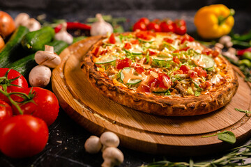 Tasty pepperoni pizza and cooking ingredients tomatoes basil on black concrete background. Top view of hot pepperoni pizza. With copy space for text. Flat lay. Banner