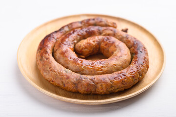 Northern Thai sausage (Sai Aua), Grilled intestine stuffed with minced pork, spices and herbs on white background, popular food in Chiangmai, Thailand