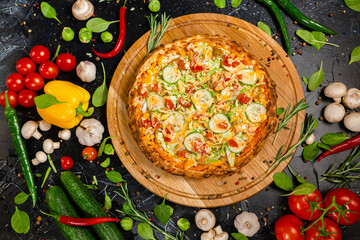 Tasty pepperoni pizza and cooking ingredients tomatoes basil on black concrete background. Top view of hot pepperoni pizza. With copy space for text. Flat lay. Banner