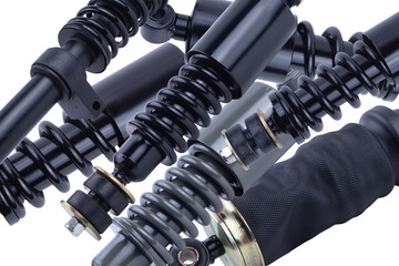 Black shock absorber for trucks on a white background with a cut-off track.