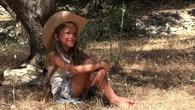 Dreaming Farmer Kid in Olive Orchard, Child by Tree,  Meditative, Thoughtful Girl on Shadow in Park, Happy Pensive Blonde Girl