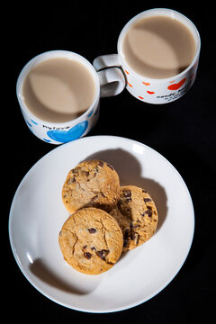 Сoffee cups and cake on the black background. Picture for the Valentine's Day