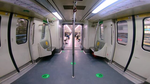 A wide shot inside a subway car