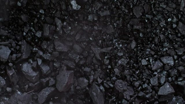 Super Slow Motion Shot of Crushing Coal on Black Background at 1000 fps.