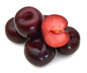 red plums isolated on white