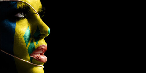 Saint Vincent and the Grenadines flag painted on a face of a young woman, national flag
