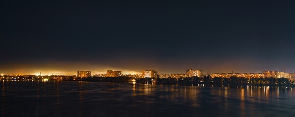 Big Dnieper river in the huge night bright city of Dnipropetrovsk in Ukraine