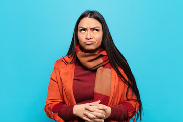 latin woman looking goofy and funny with a silly cross-eyed expression, joking and fooling around