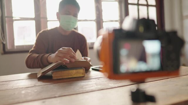 Teachers use dlsr camera equipment to teach students online from home.