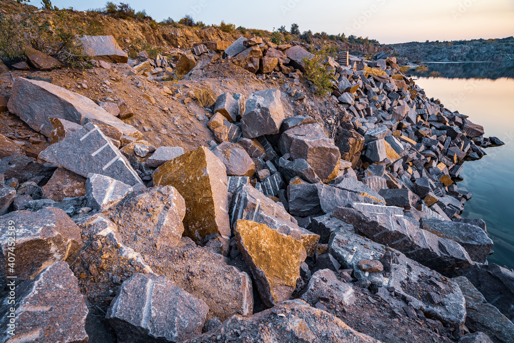 Wall mural small lake surrounded by stone waste from mine work