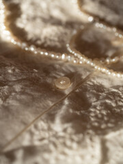 Delicate milky lace with a string of baroque pearls in the morning sun