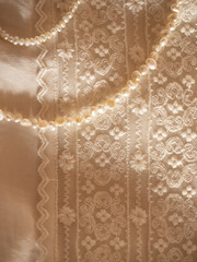 Delicate milky lace with a string of baroque pearls in the morning sun
