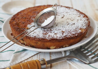 The process of making semolina pie with ingredients on a wooden background.Sprinkle cake with icing sugar.Food background.