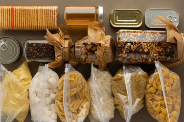 Home food supplies, necessary food for the period of quarantine and isolation, the concept of stay at home, canned food , various pasta and flour, sugar and cookies, top view