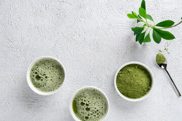 Matcha tea powder on  gray concrete background. Tea ceremony. Healthy drink. Traditional japanese drink.