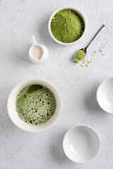 Matcha tea powder on  gray concrete background. Tea ceremony. Healthy drink. Traditional japanese drink.