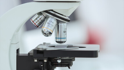 microscope with a sample on the table in the laboratory.