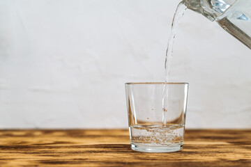 clean drinking water in a glass on white background copy space