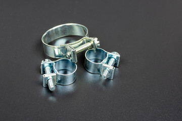 clamps in thin silver metal on a black background