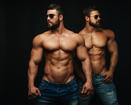 Two shirtless hunks at black background