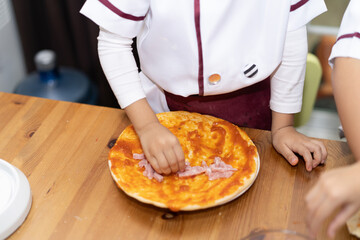 Brothers are make bun for pizza.