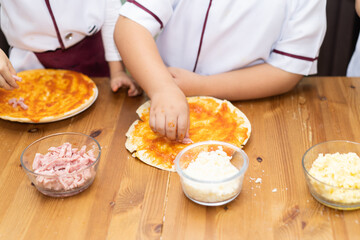 Brothers are make bun for pizza.